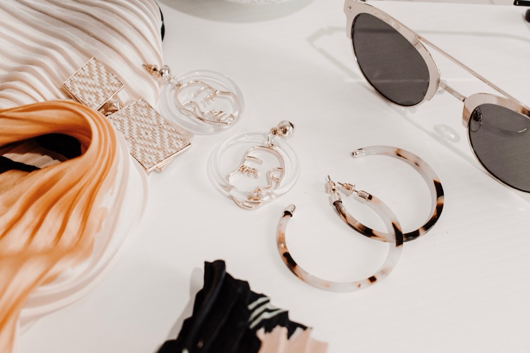 Earrings, sunglasses and a pleated scarf