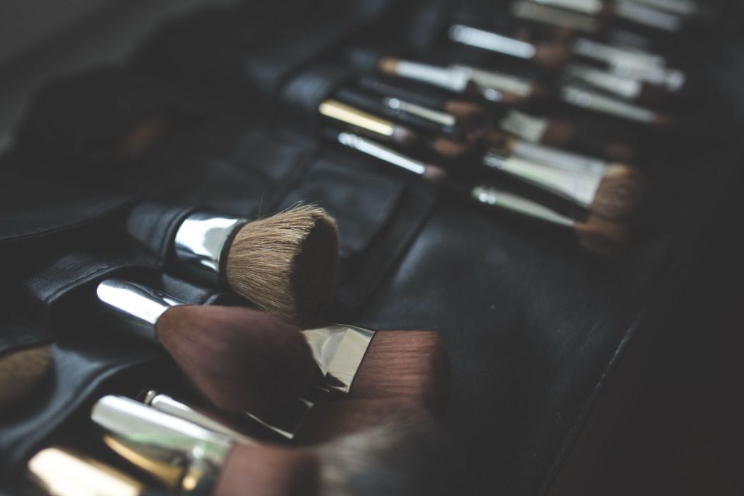 Makeup brushes in a black leather brush roll